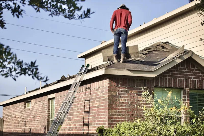 Professional roofer working on a residential roof in Holly Meadows